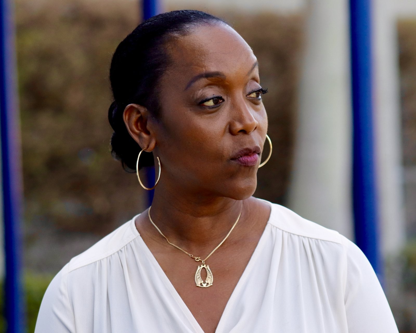 Woman in a white blouse looking to the side